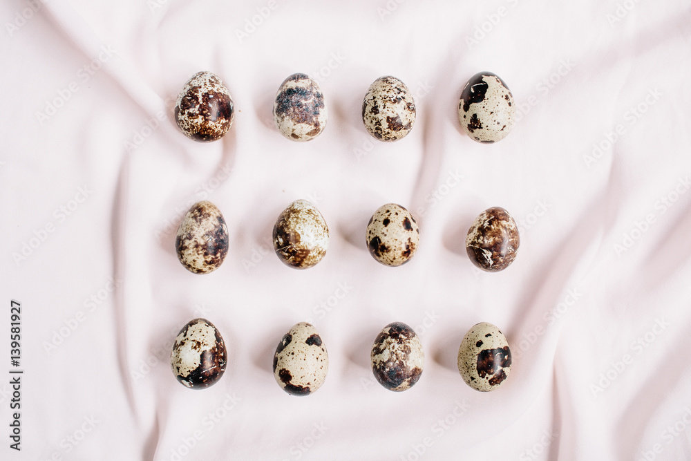 Quail eggs on pink textile background. Flat lay, top view. Easter concept. Quail eggs on pink textile background. Flat lay, top view. Easter concept.