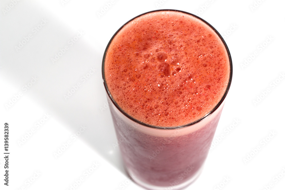 A glass of red healthy juice isolated over a white background A glass of red healthy juice isolated over a white background