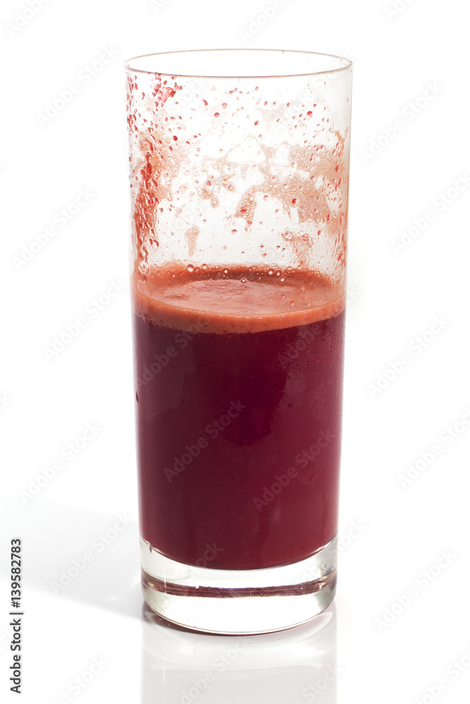 A glass of half full red healthy juice isolated over a white background A glass of half full red healthy juice isolated over a white background
