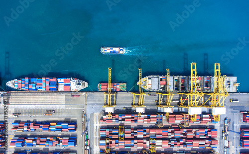 container ship in import export and business logistic.By crane ,Trade Port , Shipping.cargo to harbor.Aerial view.Top view.