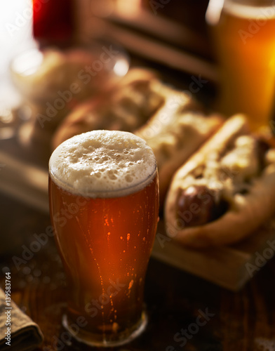 freshlly poured IPA beer in mug served with bratwursts