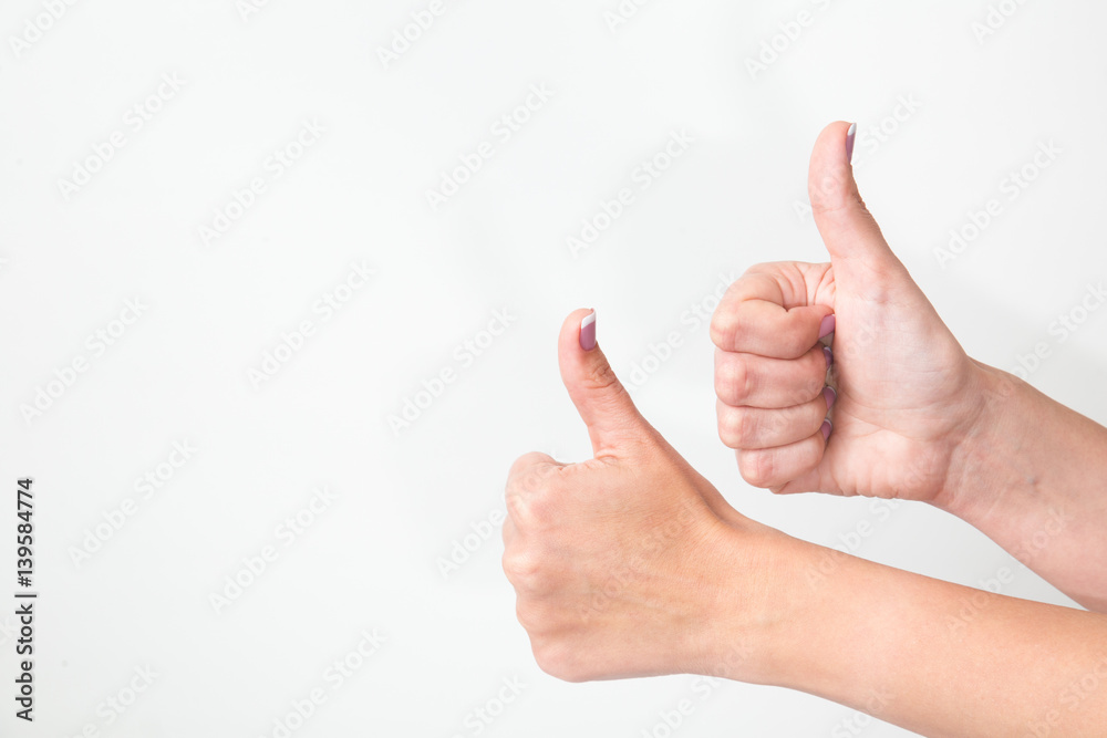 Close up of two female caucasian hands isolated on white background. Young woman shows both hands with thumbs up as sign of success. Horizontal color image. Close up of two female caucasian hands isolated on white background. Young woman shows both hands with thumbs up as sign of success. Horizontal color image.