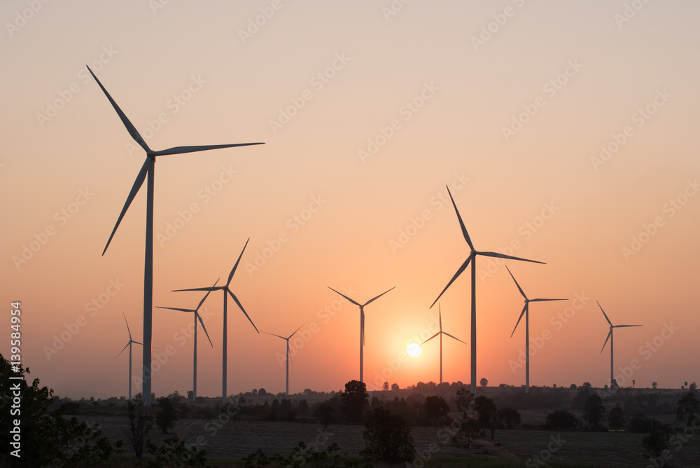 silhouette of wind turbines at sunset silhouette of wind turbines at sunset