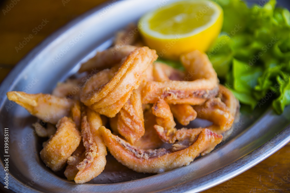 Tasty fried squids dish - spanish traditional tapa Tasty fried squids dish - spanish traditional tapa