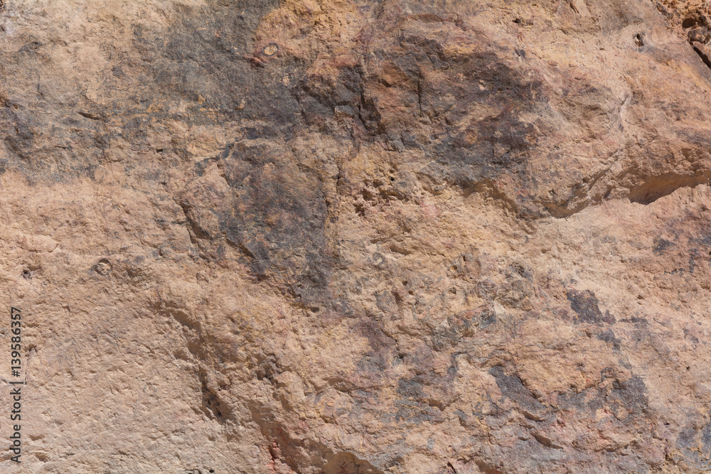 Textured surface of colorful rock