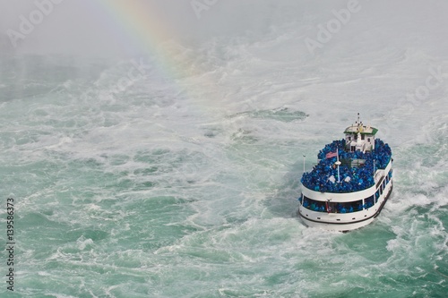 Beautiful isolated photo of a ship near amazing Niagara waterfall photo