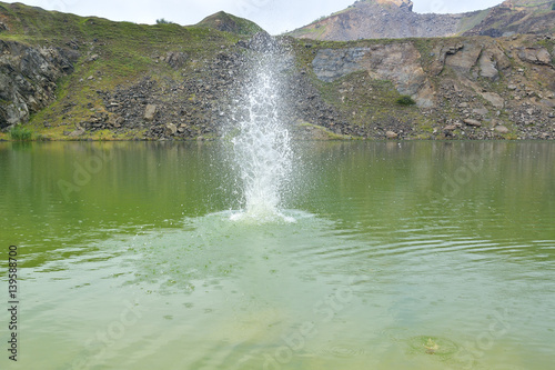 big water splash in lake after diving