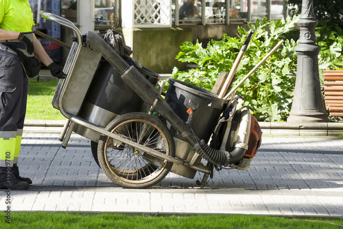 utility worker of  municipality service  sweep in pulbic park photo