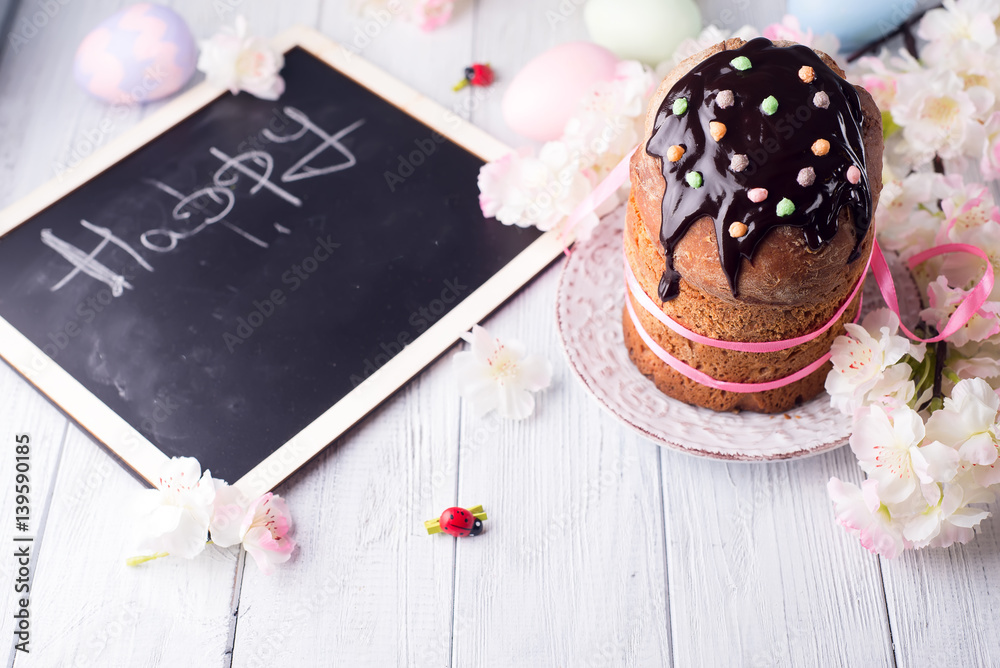 Fototapeta premium Easter cake with colored eggs and board for chalk