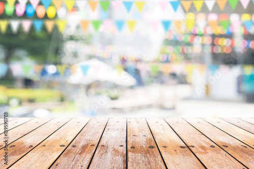 Empty wooden table with party in garden background blurred. Fototapete