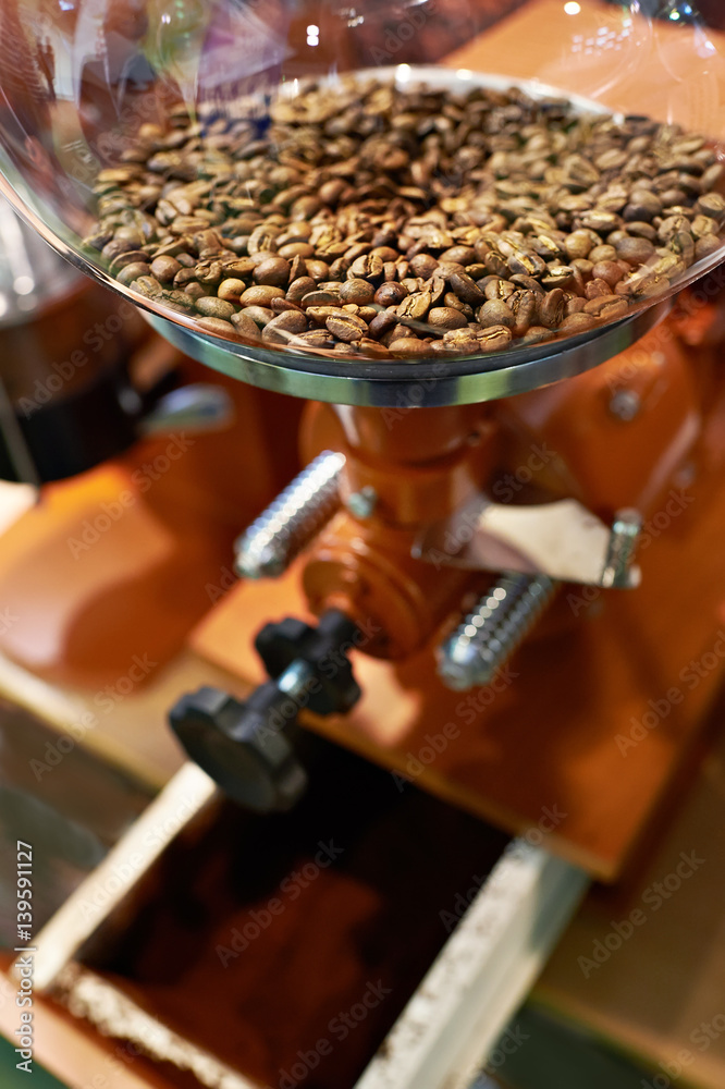 Coffee beans in grinder with millstones Coffee beans in grinder with millstones
