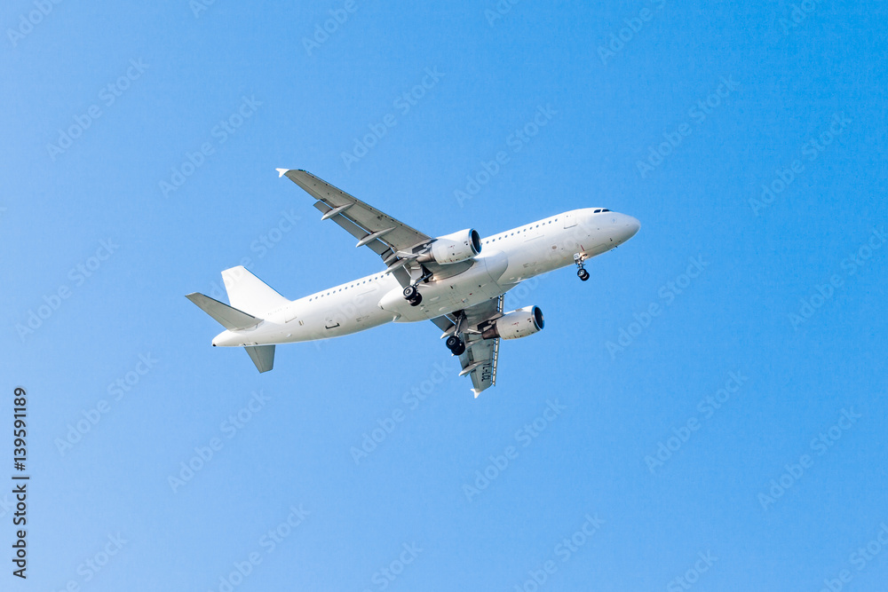 white airplane on a blue background. airplane in the sky white airplane on a blue background. airplane in the sky
