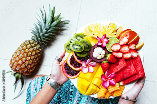 Fototapeta Naklejka Na Ścianę i Meble -  Hands holding fresh fruit plate