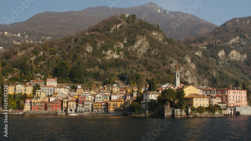 The beautiful shores of Lake Como with the town of Varenna and the Italian Alps in background. View from ferry. © ramiai
