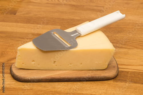 Piece of cheese with a slicer