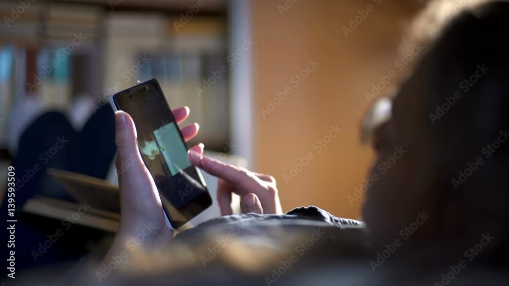 Woman at home looking pictures on your phone Woman at home looking pictures on your phone
