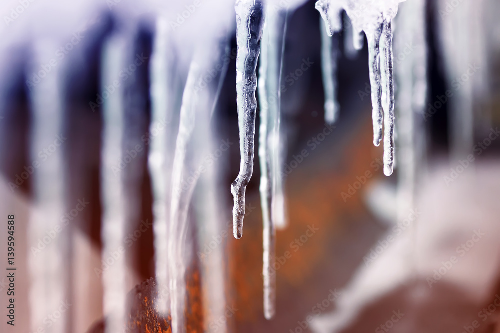  icicles hang in a Sunny spring day and shimmer