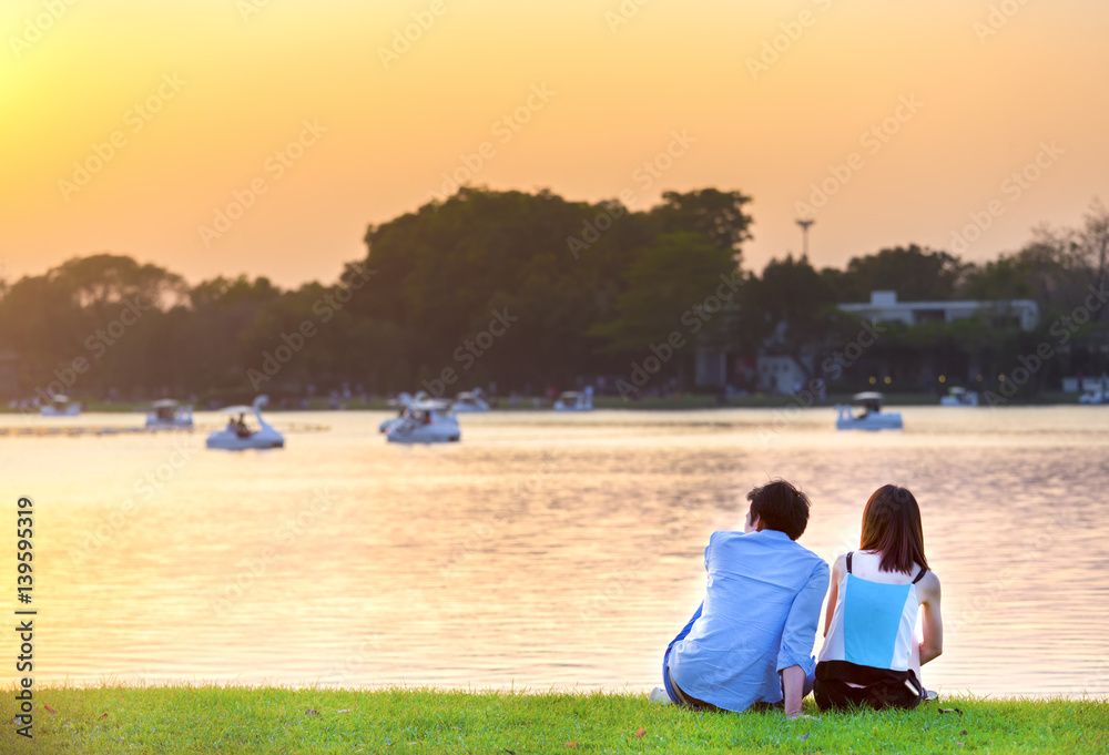 Young people will find happiness at the park and beautiful with sunset have orange color Young people will find happiness at the park and beautiful with sunset have orange color