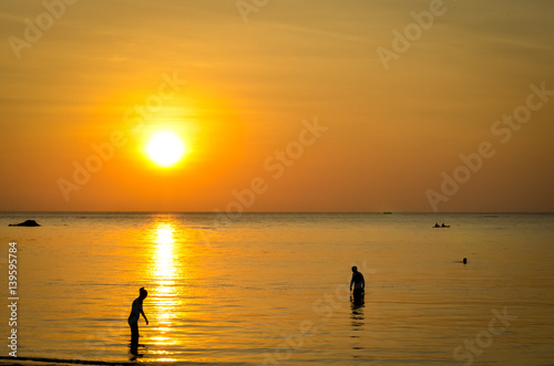 sunset at tropical beach with silhouettes © busenlilly666
