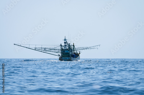 blue Fishing trawler on the ocean water