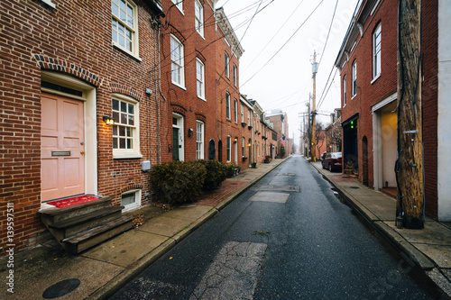 Narrow alley and row houses in Fells Point, Baltimore, Maryland.
