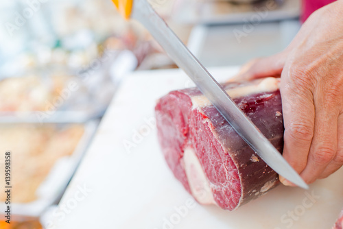 Butcher slicing beef