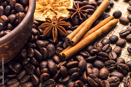 Coffee beans into bowl with cinnamon and anise