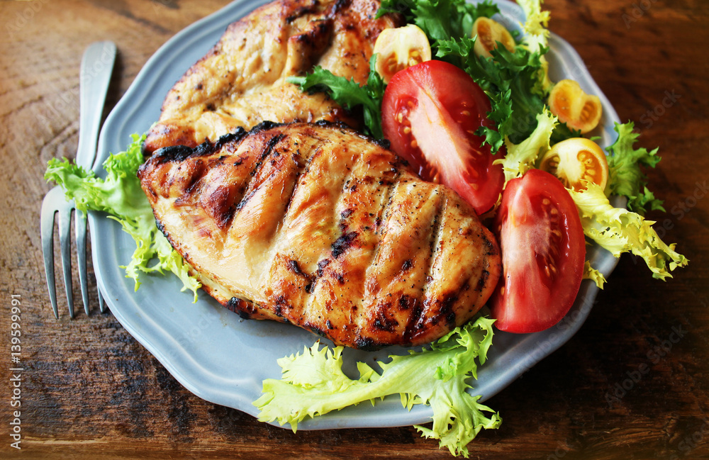 Grilled chicken breast on wooden background