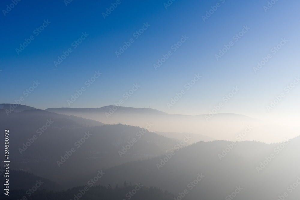 View from Yburg castle in direction mountain Hornisgrinde with fog in the valley