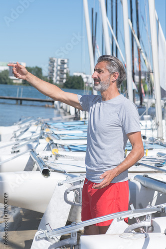 attractive sailor rigging hobbie-cat before sailing course