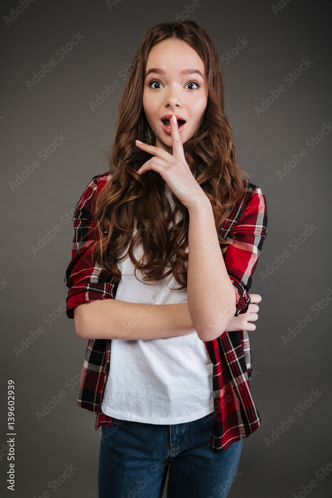 Surprised pretty young woman standing with opened mouth Surprised pretty young woman standing with opened mouth