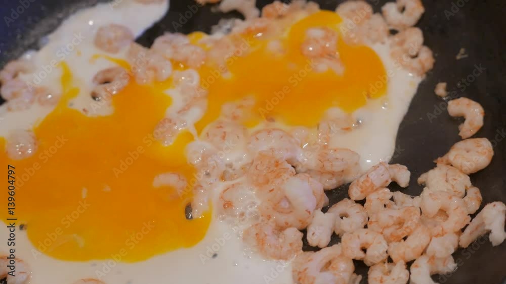 Close up of fried shrimps with eggs in a frying pan with oil. 4K UHD Close up of fried shrimps with eggs in a frying pan with oil. 4K UHD