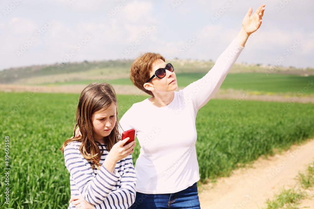 Happy mother and daughter in spring blossom park. Mother day. Happy mother and daughter in spring blossom park. Mother day.