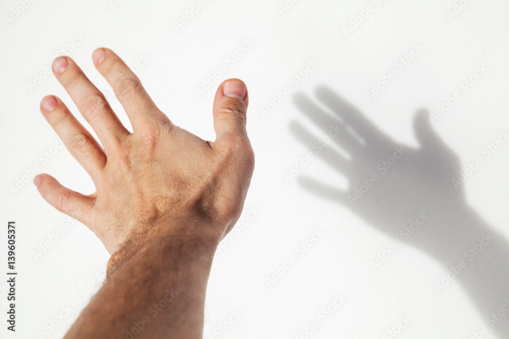 Male hand over white wall background Male hand over white wall background