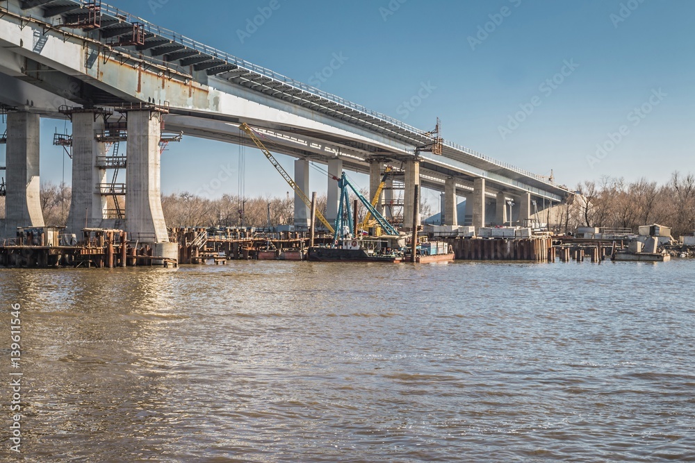 Construction of a bridge across the river. Stock image. Construction of a bridge across the river. Stock image.