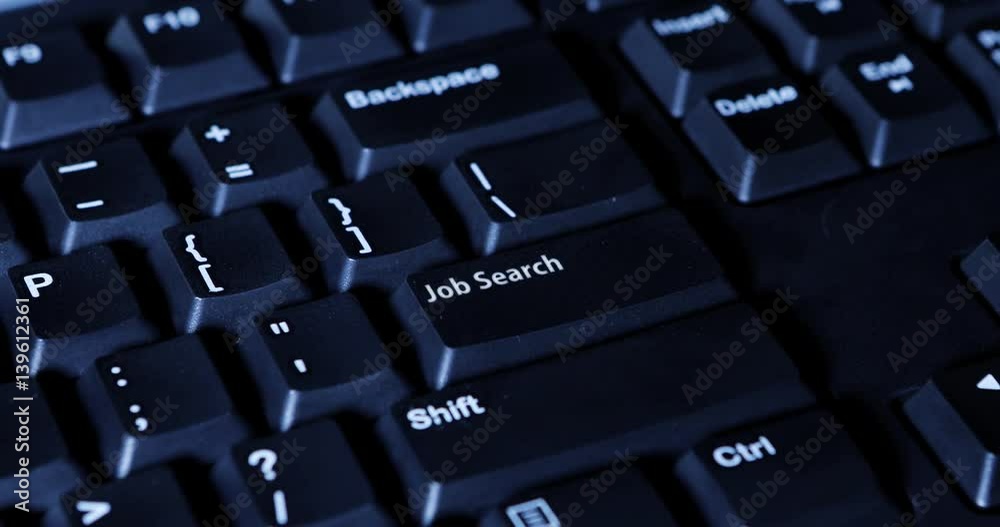Close up of human finger pressing a job search button on the computer keyboard Close up of human finger pressing a job search button on the computer keyboard