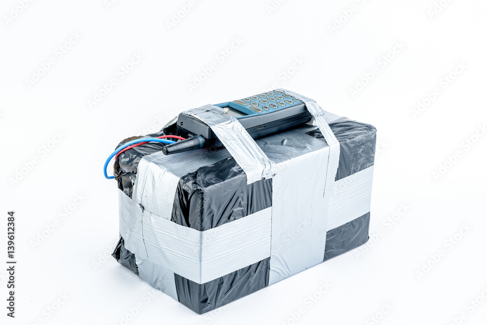 adio-controlled bomb with lcd screen, cell phone and colored wires on a white background. Concept image of terrorism, Explosion adio-controlled bomb with lcd screen, cell phone and colored wires on a white background. Concept image of terrorism, Explosion