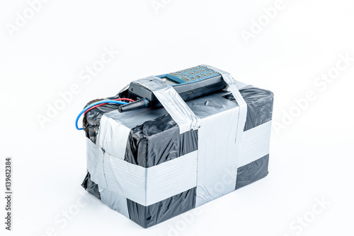 adio-controlled bomb with lcd screen, cell phone and colored wires on a white background. Concept image of terrorism, Explosion