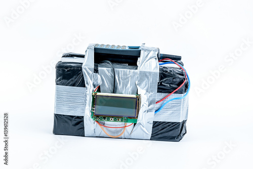 adio-controlled bomb with lcd screen, cell phone and colored wires on a white background. Concept image of terrorism, Explosion
