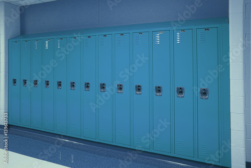 A row of lockers sit quietly in the school hallway