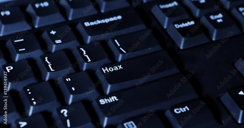 Male finger pushing Hoax button on the computer keyboard Male finger pushing Hoax button on the computer keyboard