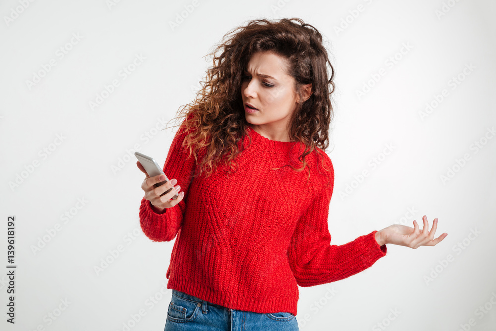 Disappointed confused woman using smartphone Disappointed confused woman using smartphone