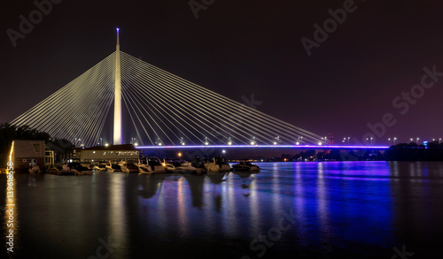 Beautiful Ada bridge in Belgrade, Serbia at night photo