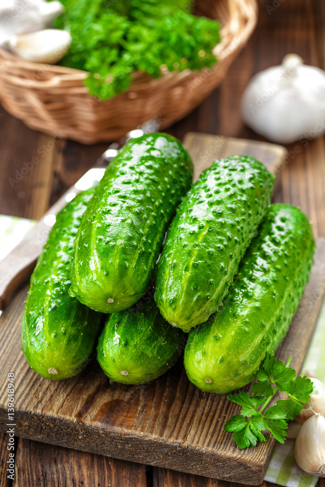 Fresh cucumbers on wooden background close up