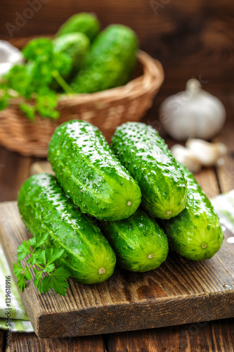 Fresh cucumbers on wooden background close up