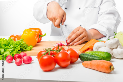 hand cook cut vegetables for salad close up on a wooden board