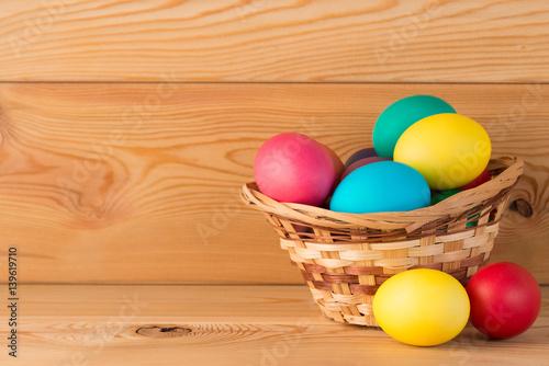 Wallpaper Mural on wooden boards Easter composition with colored eggs in a basket Torontodigital.ca