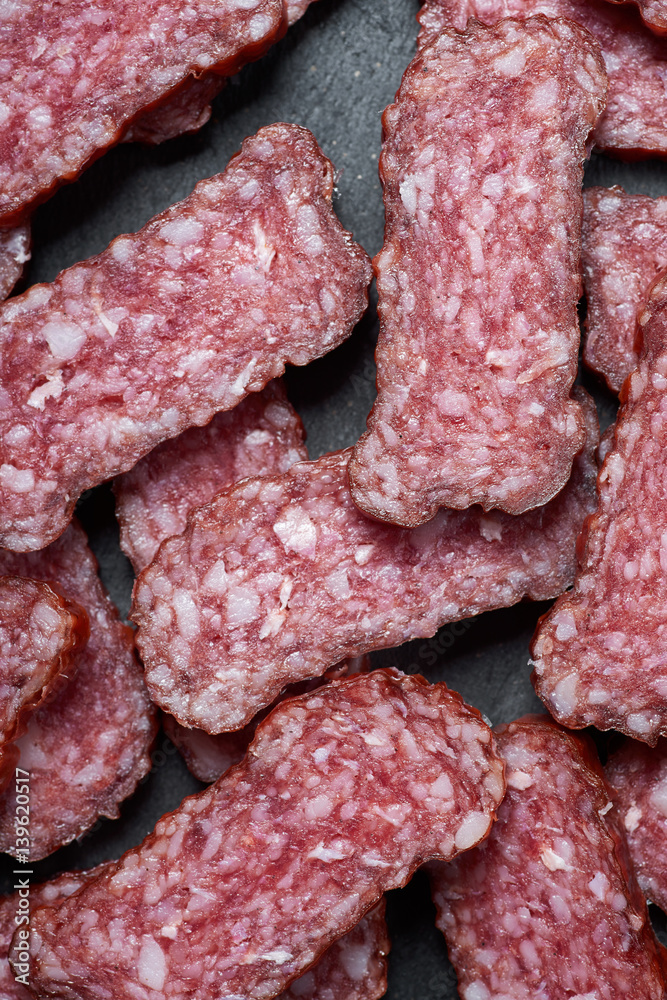Sliced salami on a stone board Sliced salami on a stone board