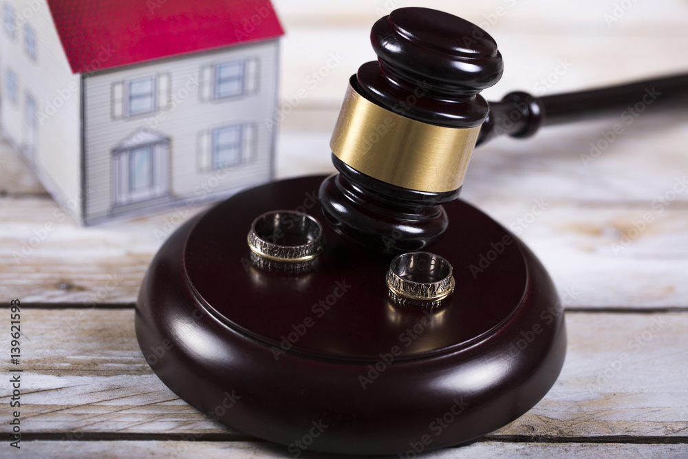 Family law concept. Divorce. Gavel, house and rings