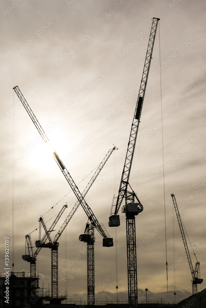 Cranes silhouette on construction site Cranes silhouette on construction site
